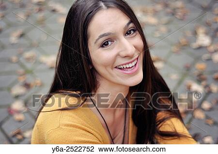 Stock Image - Portrait of a smiling young woman.. Fotosearch