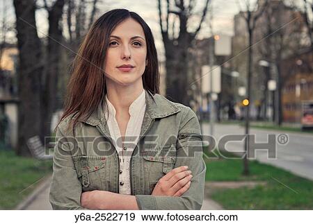 Stock Photo - Portrait of a young woman on city street.. Fotosearch