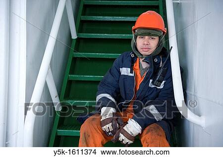 Picture - Portrait of an Indonesian seaman or sailor on the container-vessel MV Flintercape, during a journey from Rotterdam, Netherlands, to Sundsvall, Sweden. The man is an ´Able Seaman´, who generally works on deck.. Fotosearch