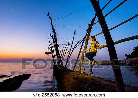 Posing young woman in late sunset light. View Large Photo Image Stock Photo - Posing young woman in late sunset light.. Fotosearch