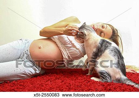 Pregnant woman plays with her cat. Toxoplasmosis - Parasites from the cat can be harmful to the unborn baby. Model release available. View Large Photo Image Stock Image - Pregnant woman plays with her cat. Toxoplasmosis - Parasites from the cat can be harmful to the unborn baby. Model release available.. Fotosearch