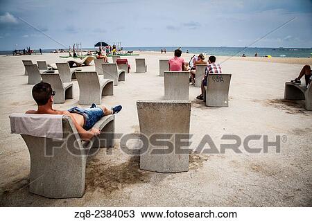 Stock Image - Resting at the Barceloneta Beach.. Fotosearch