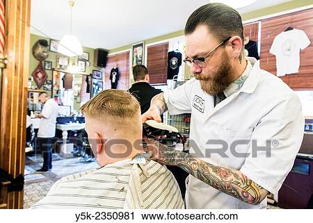 Rotterdam, Netherlands. Barber store Schorem. Barber helping his customer in his barber shop by cutting and modeling his hair. View Large Photo Image Stock Image - Rotterdam, Netherlands. Barber store Schorem. Barber helping his customer in his barber shop by cutting and modeling his hair.. Fotosearch