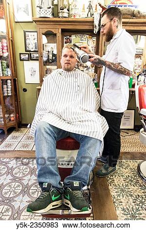 Rotterdam, Netherlands. Barber store Schorem. Barber helping his customer in his barber shop by cutting and modeling his hair. View Large Photo Image Stock Image - Rotterdam, Netherlands. Barber store Schorem. Barber helping his customer in his barber shop by cutting and modeling his hair.. Fotosearch