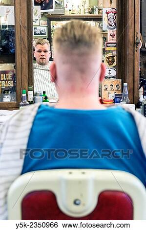 Rotterdam, Netherlands. Barber store Schorem. Male customer looking into the barbers mirror after having his hair cut and modeled. View Large Photo Image Stock Photograph - Rotterdam, Netherlands. Barber store Schorem. Male customer looking into the barbers mirror after having his hair cut and modeled.. Fotosearch