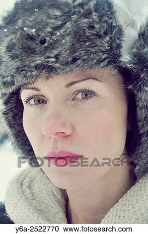 Stock Image - Serious mid adult woman portrait, winter. Fotosearch