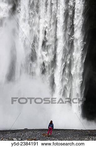 single female in front of Skogafoss waterfall, Iceland. View Large Photo Image Stock Image - single female in front of Skogafoss waterfall, Iceland.. Fotosearch
