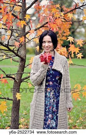 Smiling mid adult woman portrait, autumn View Large Photo Image Picture - Smiling mid adult woman portrait, autumn. Fotosearch
