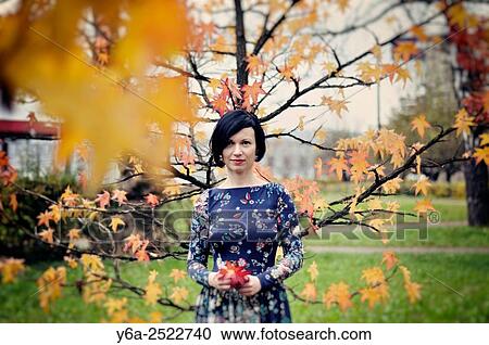Smiling mid adult woman portrait, autumn View Large Photo Image Stock Image - Smiling mid adult woman portrait, autumn. Fotosearch