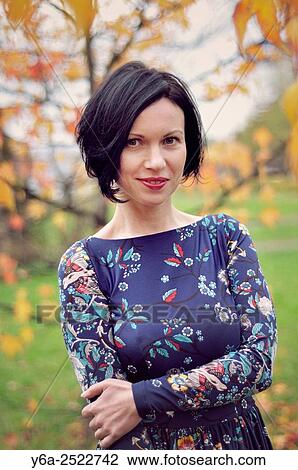 Smiling mid adult woman portrait, autumn View Large Photo Image Stock Image - Smiling mid adult woman portrait, autumn. Fotosearch