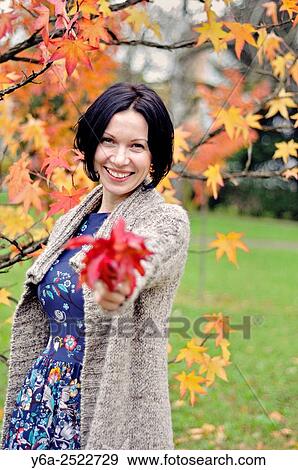 Smiling mid adult woman portrait, autumn View Large Photo Image Stock Photo - Smiling mid adult woman portrait, autumn. Fotosearch