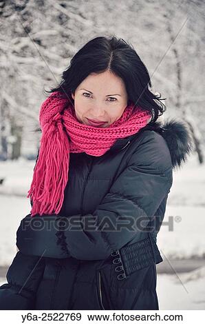 Stock Photo - Smiling mid adult woman portrait, winter. Fotosearch