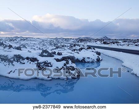 Stock Photo - Snow covered lava and fresh water by the Hitaveita Sudurnesja geothermal power plant, Iceland.. Fotosearch
