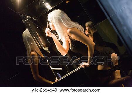 Stock Photo - Stock Photo - Applying makeup in closet young woman. Fotosearch