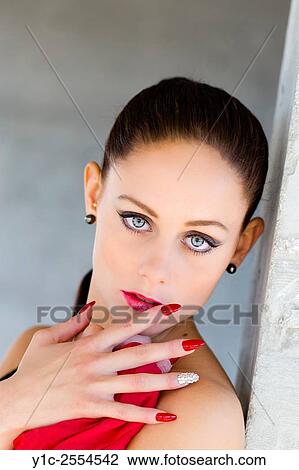 Stock Image - Stock Photo - Pretty teen girl portrait Red lips long Red nails. Fotosearch