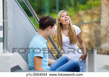 Stock Photo - Teen couple she shows tongue View Large Photo Image Picture - Stock Photo - Teen couple she shows tongue. Fotosearch
