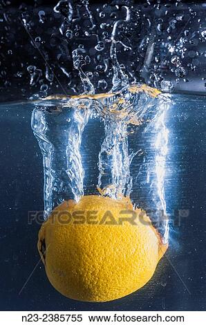 Stock Photography - Studio photography, lemon dipping, SPAIN. Fotosearch