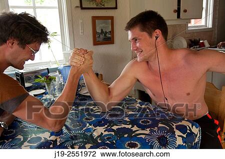 Stock Image - Summer cottage holiday brothers, J? mtland, Sweden arm wrestle. Fotosearch