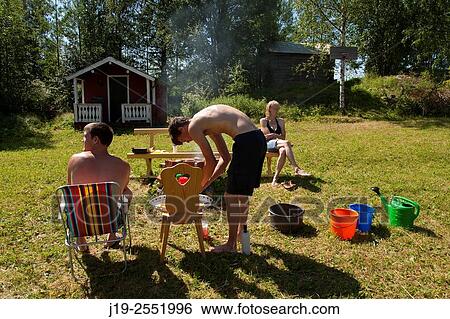 Stock Photograph - Summer cottage holiday J? mtland Sweden family dinner.. Fotosearch