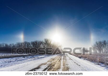 Sun dogs form over western Iowa thanks to ice crystals off a steamy Missouri River during a very cold morning. View Large Photo Image Stock Image - Sun dogs form over western Iowa thanks to ice crystals off a steamy Missouri River during a very cold morning.. Fotosearch