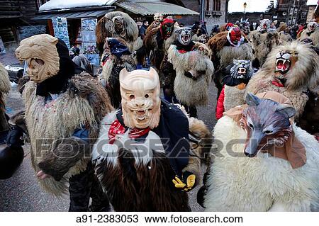 Switzerland, Valais, Val d? Herens, village of Evolene, Carnaval, peluches disguisment of young people and children dressed with a coat made of animal fur and a carved traditional wooden mask made in the village representing mythical animals. View Large Photo Image Stock Image - Switzerland, Valais, Val d? Herens, village of Evolene, Carnaval, peluches disguisment of young people and children dressed with a coat made of animal fur and a carved traditional wooden mask made in the village representing mythical animals.. Fotosearch