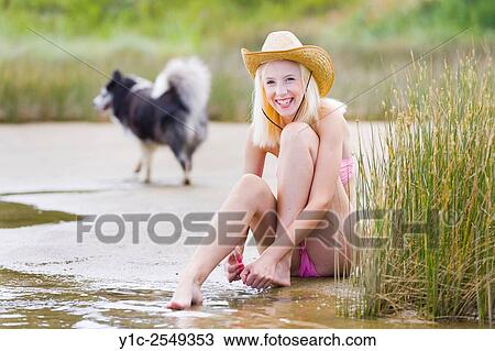 Stock Image - Teen girl and dog passing by. Fotosearch