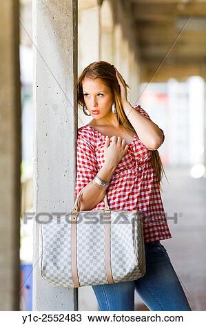 Stock Image - Teen girl hidden and on watch. Fotosearch