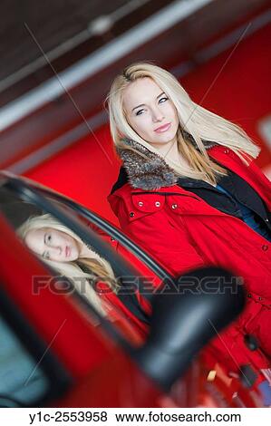 Stock Photo - Teen girl next to car with reflection in glass. Fotosearch