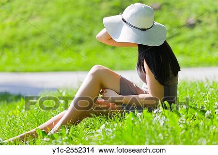 Picture - Teen girl on sunny greenfield. Fotosearch