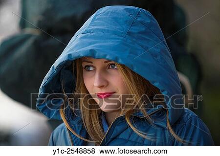 Stock Photo - Teen girl portrait cold under hood.. Fotosearch
