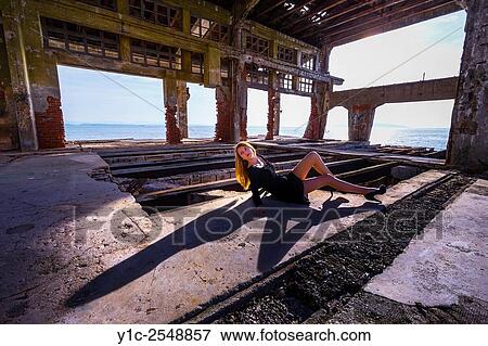Stock Photo - Teen girl posing reclining casting shadow.. Fotosearch