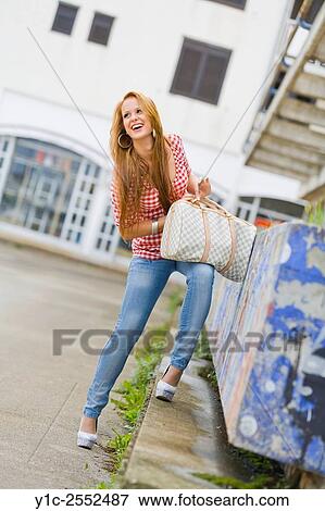 Stock Photo - Teen girl with handbag in hand.. Fotosearch