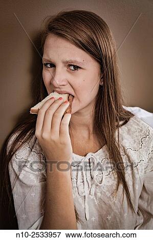 Teenage girl eating a sandwich. View Large Photo Image Stock Photo - Teenage girl eating a sandwich.. Fotosearch