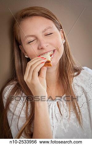 Teenage girl eating a sandwich. View Large Photo Image Stock Photograph - Teenage girl eating a sandwich.. Fotosearch