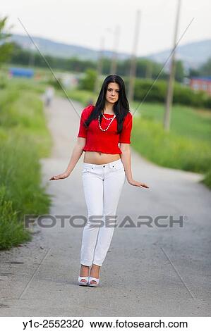 Stock Image - Teenager girl posing on small road.. Fotosearch