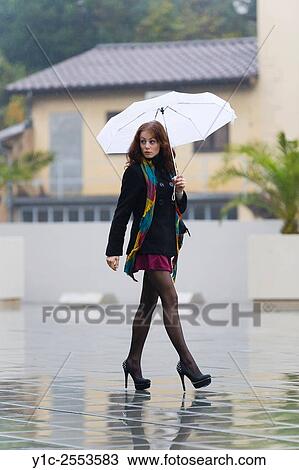 Teenager girl street-walking on rainy day View Large Photo Image Stock Image - Teenager girl street-walking on rainy day. Fotosearch
