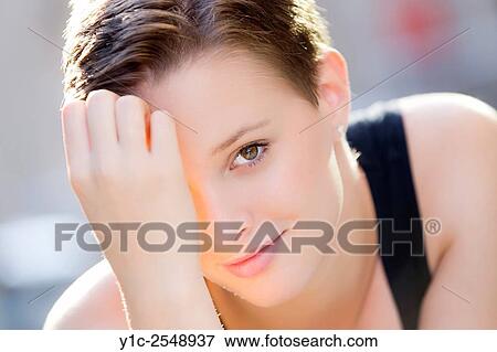 Stock Photo - Teengirl portrait peeking on one eye. Fotosearch
