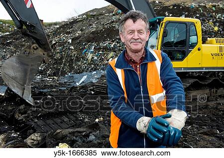 This 67-year old man still works as a freelance machinist on an excavator on top of the regional dump-site near Tilburg, The Netherlands. He does his job full of joy! View Large Photo Image Stock Photography - This 67-year old man still works as a freelance machinist on an excavator on top of the regional dump-site near Tilburg, The Netherlands. He does his job full of joy!. Fotosearch