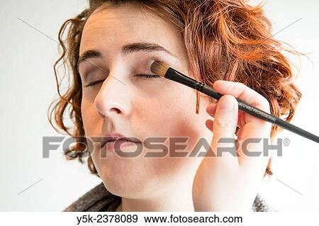 Tilburg, Netherlands. Young, brunette beautician applying male up to her customers face. View Large Photo Image Stock Photo - Tilburg, Netherlands. Young, brunette beautician applying male up to her customers face.. Fotosearch