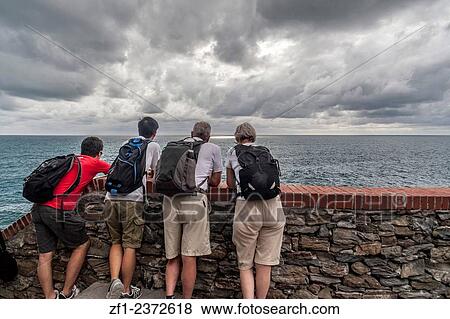 Tourists looking sea in Riomaggiore, Liguria, Italy. View Large Photo Image Stock Photo - Tourists looking sea in Riomaggiore, Liguria, Italy.. Fotosearch