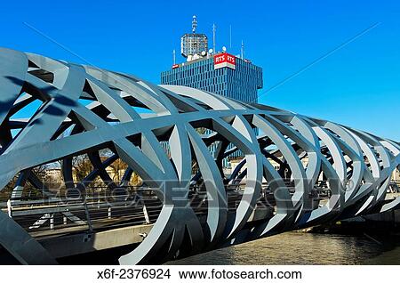 Tower of the French-speaking Swiss public broadcasting station Radio T? l? vision Suisse, RTS, behind the tube-shaped spatial structure of the Hans-Wilsdorf-bridge, Geneva, Switzerland. View Large Photo Image Picture - Tower of the French-speaking Swiss public broadcasting station Radio T? l? vision Suisse, RTS, behind the tube-shaped spatial structure of the Hans-Wilsdorf-bridge, Geneva, Switzerland.. Fotosearch