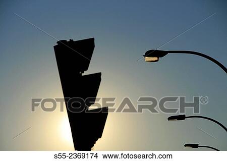 Picture - Traffic light and street lights in the sunset. Barcelona, Catalonia, Spain. Fotosearch