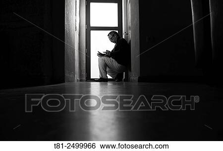 Troubled man looking at a mobile phone View Large Photo Image Stock Photograph - Troubled man looking at a mobile phone. Fotosearch