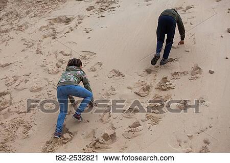 two children up sand dune View Large Photo Image Stock Image - two children up sand dune. Fotosearch
