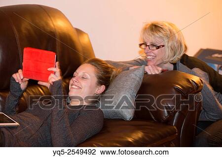 Stock Image - two women using digital tablet computer.. Fotosearch