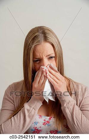 Using a handkerchief, a young adult woman blows her nose in Laguna Beach, CA. Note Cardigan sweater. MODEL RELEASE. View Large Photo Image Stock Image - Using a handkerchief, a young adult woman blows her nose in Laguna Beach, CA. Note Cardigan sweater. MODEL RELEASE.. Fotosearch