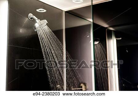 Stock Image - Water spraying out of a shower head.. Fotosearch