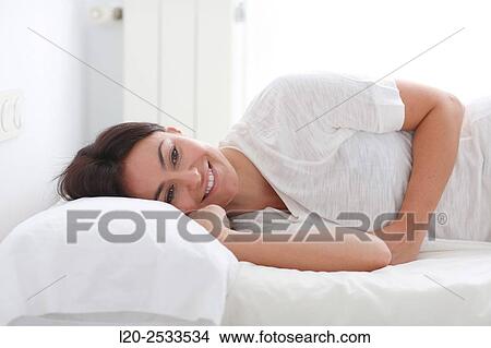 Woman in bed View Large Photo Image Picture - Woman in bed. Fotosearch