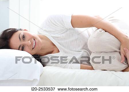 Woman in bed View Large Photo Image Stock Photo - Woman in bed. Fotosearch