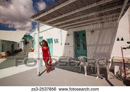 Woman posing at the terrace of a whitewashed Cyclades house in Faros village, Sifnos, Cyclades Islands, Greek Islands, Greece, Europe. View Large Photo Image Stock Photograph - Woman posing at the terrace of a whitewashed Cyclades house in Faros village, Sifnos, Cyclades Islands, Greek Islands, Greece, Europe.. Fotosearch